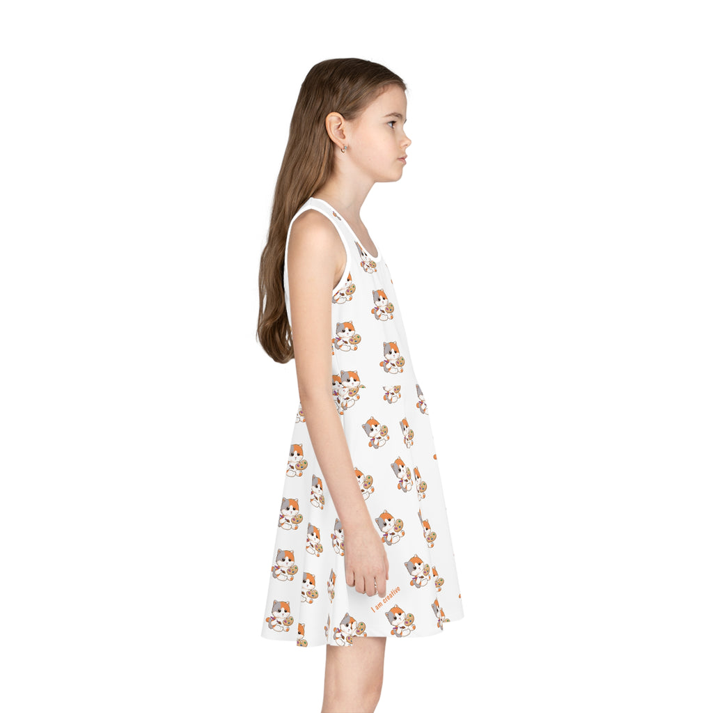 Right side-view of a girl wearing a sleeveless white dress with a repeating pattern of a cat.