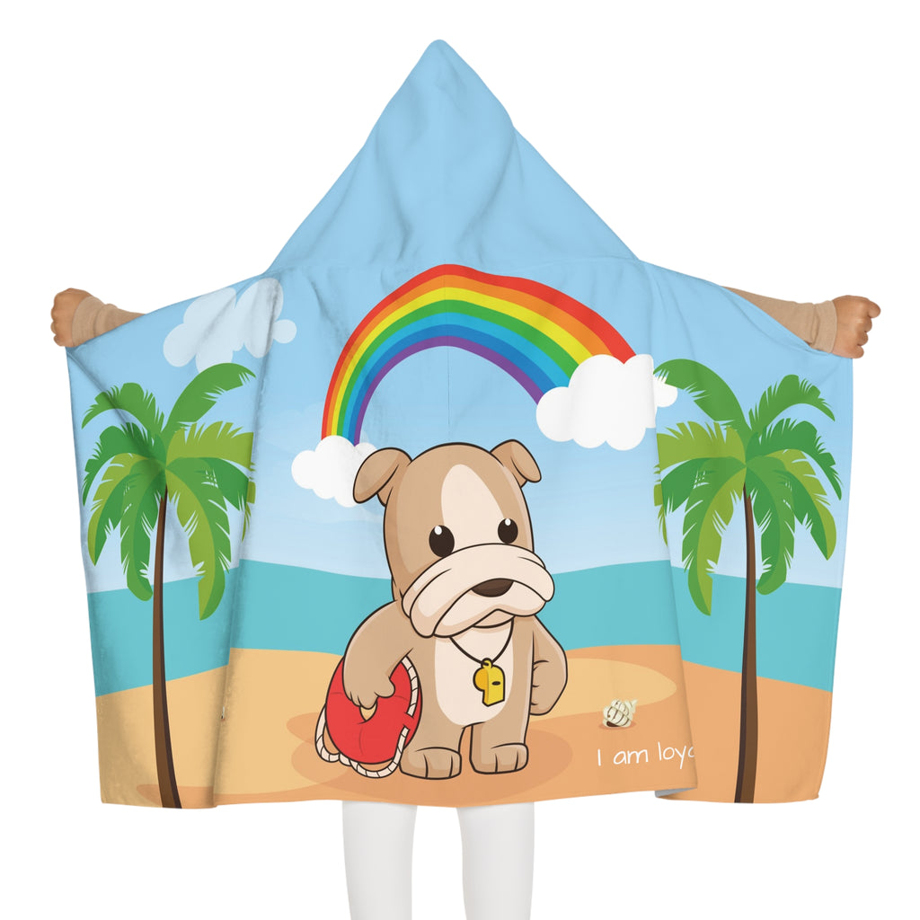 Back-view of a girl wearing a hooded towel and holding it open. The towel has a scene of a dog lifeguard standing on the beach, a rainbow in the background, and the phrase "I am loyal" along the bottom.