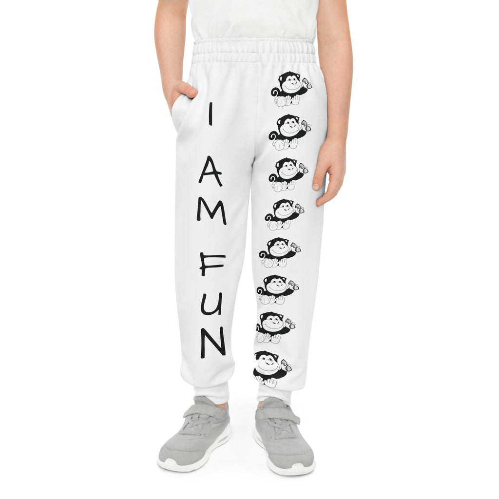 Front-view of a boy wearing white sweatpants with a line of black and white monkeys down the front left leg and the phrase "I am fun" down the front right leg.