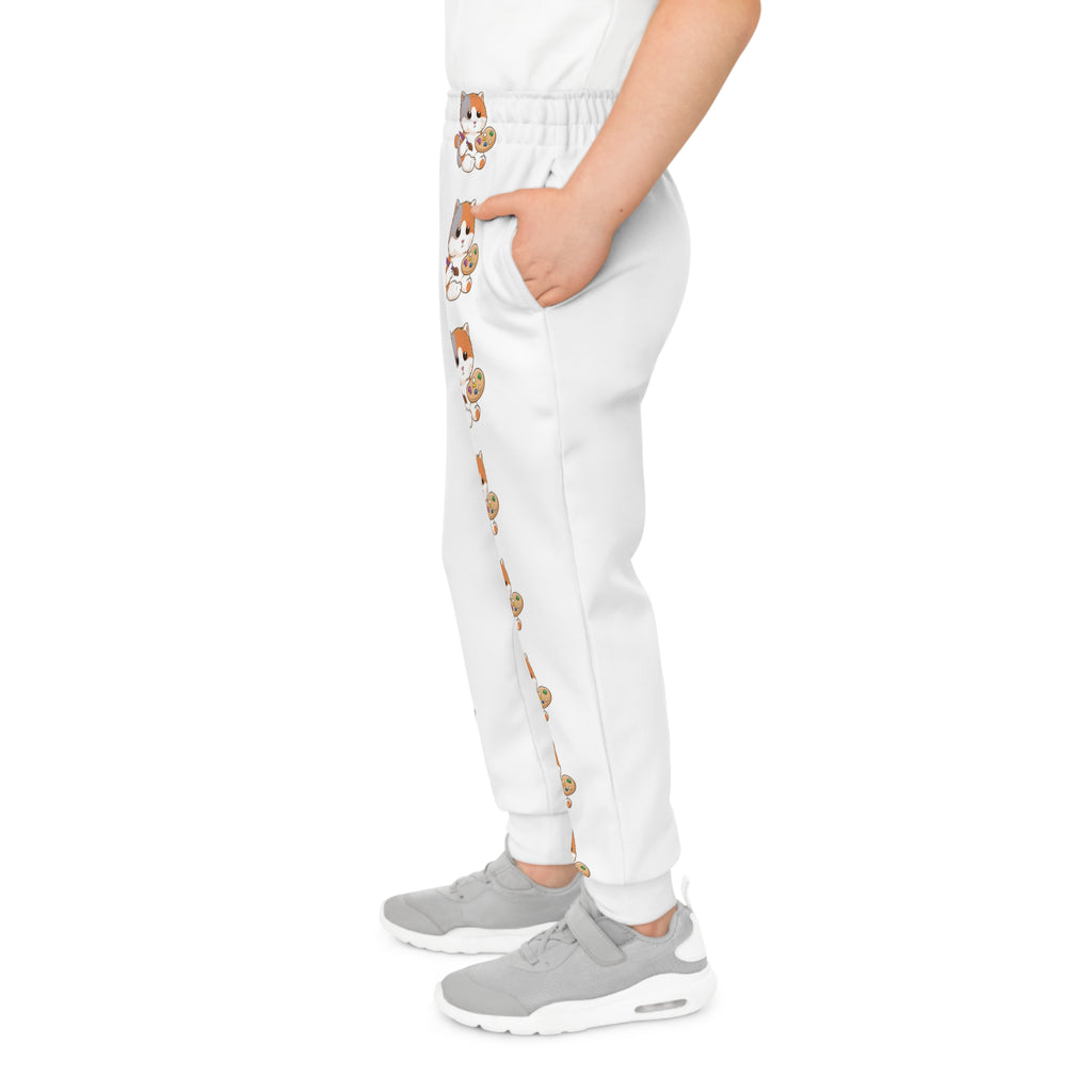 Left side-view of a boy wearing white sweatpants with a line of cats down the front left leg.