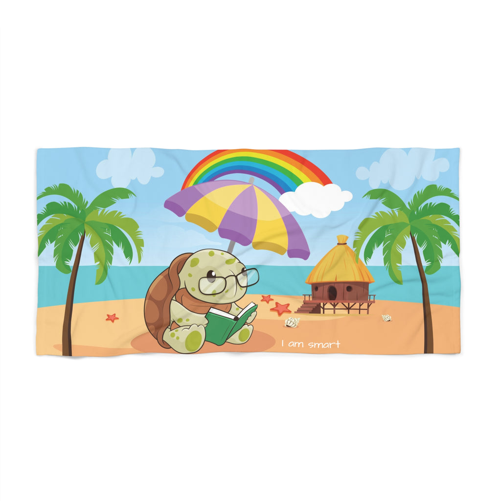 A 36 by 72 inch beach towel with a scene of a turtle reading a book under an umbrella on the beach, a rainbow in the background, and the phrase "I am smart" along the bottom.