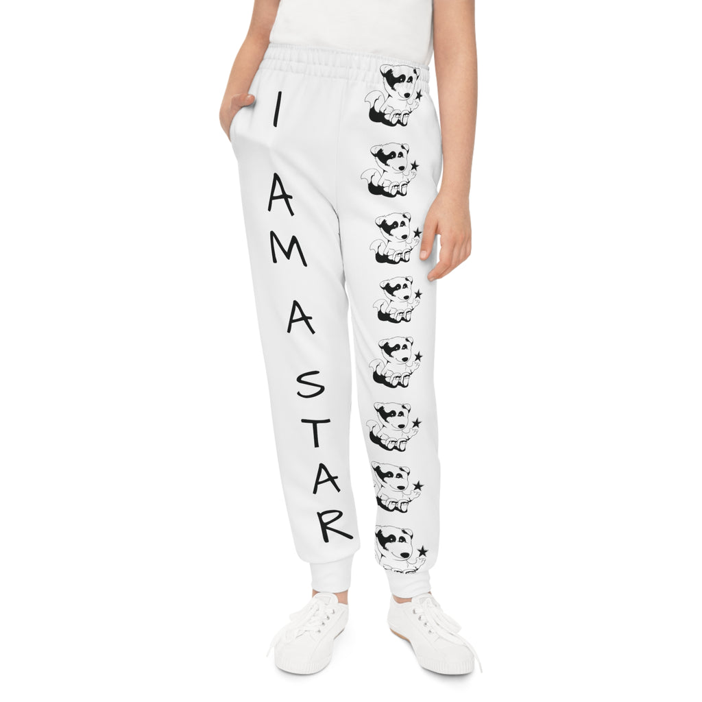 Front-view of a girl wearing white sweatpants with a line of black and white foxes down the front left leg and the phrase "I am a star" down the front right leg.