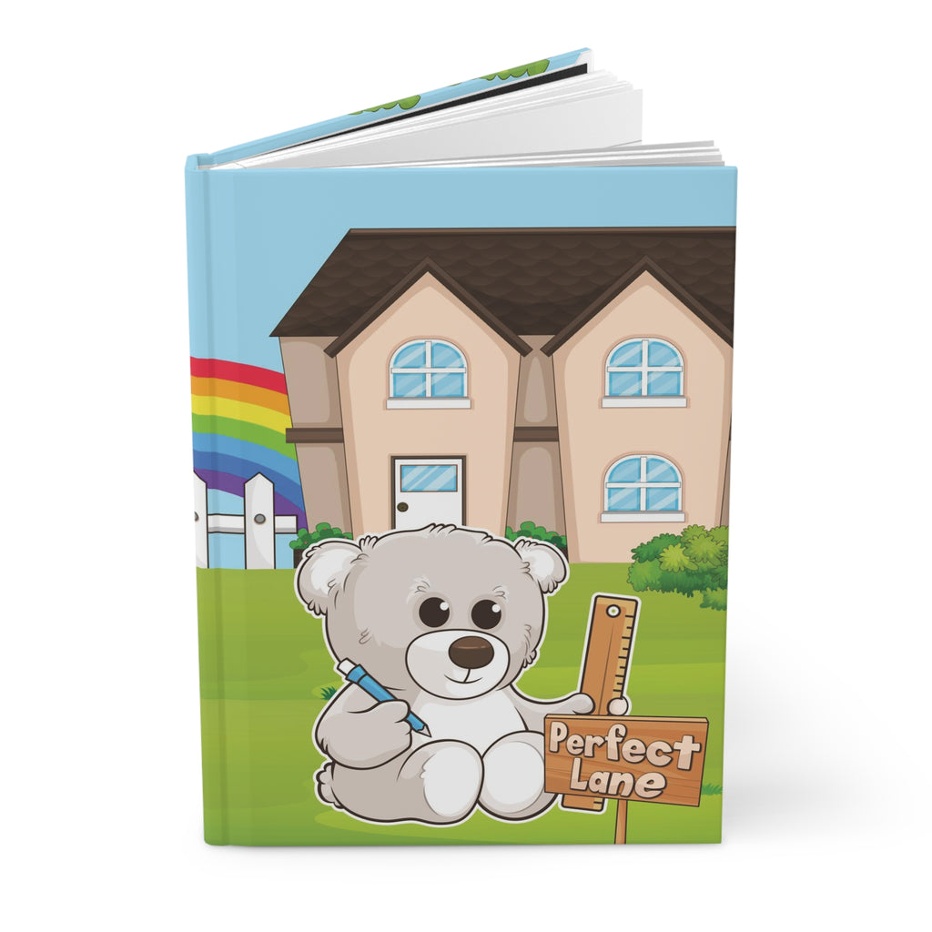 A hardcover journal standing up. The journal cover is a scene of a bear in the yard of its house with a rainbow in the background.