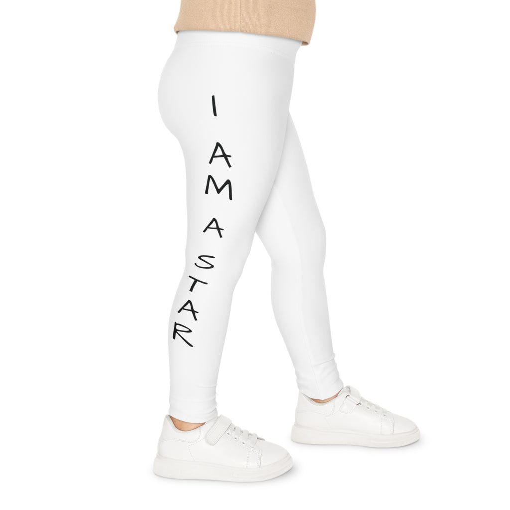 Right side-view of a child wearing white leggings with the phrase "I am a star" read top to bottom on the side of the leg.