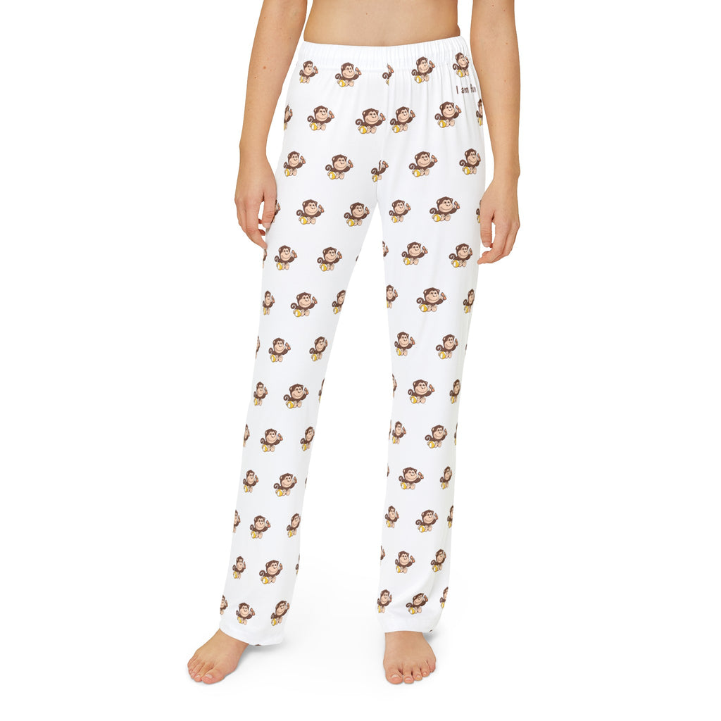 Front-view of a kid wearing white pajama pants with a repeated pattern of a monkey and the phrase “I am fun” on the front left waist.