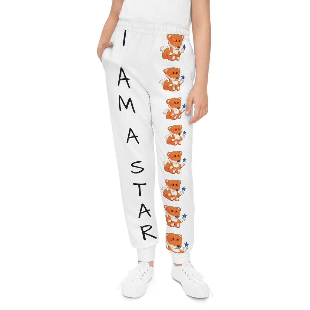 Front-view of a girl wearing white sweatpants with a line of foxes down the front left leg and the phrase "I am a star" down the front right leg.