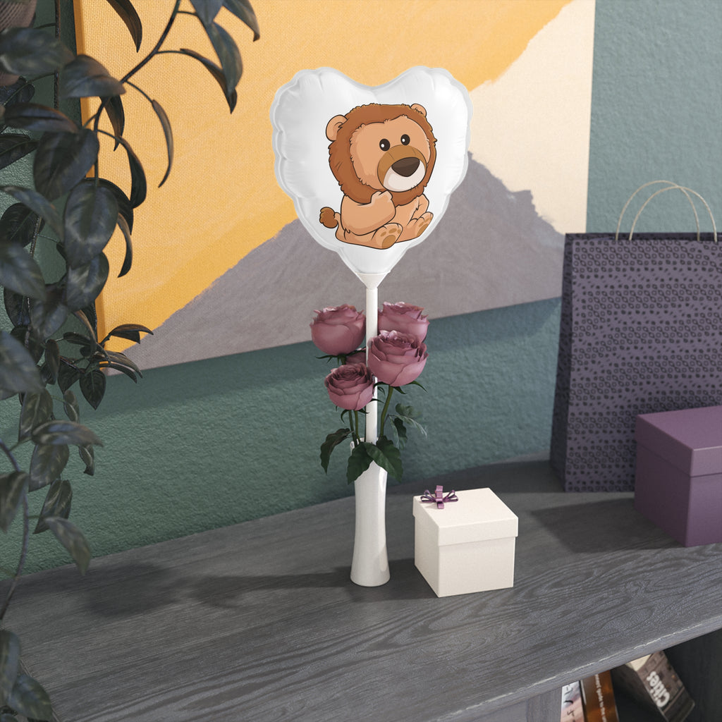 A heart-shaped white mylar balloon on a stick with a picture of a lion. The balloon sits in a flower vase on a gift table.