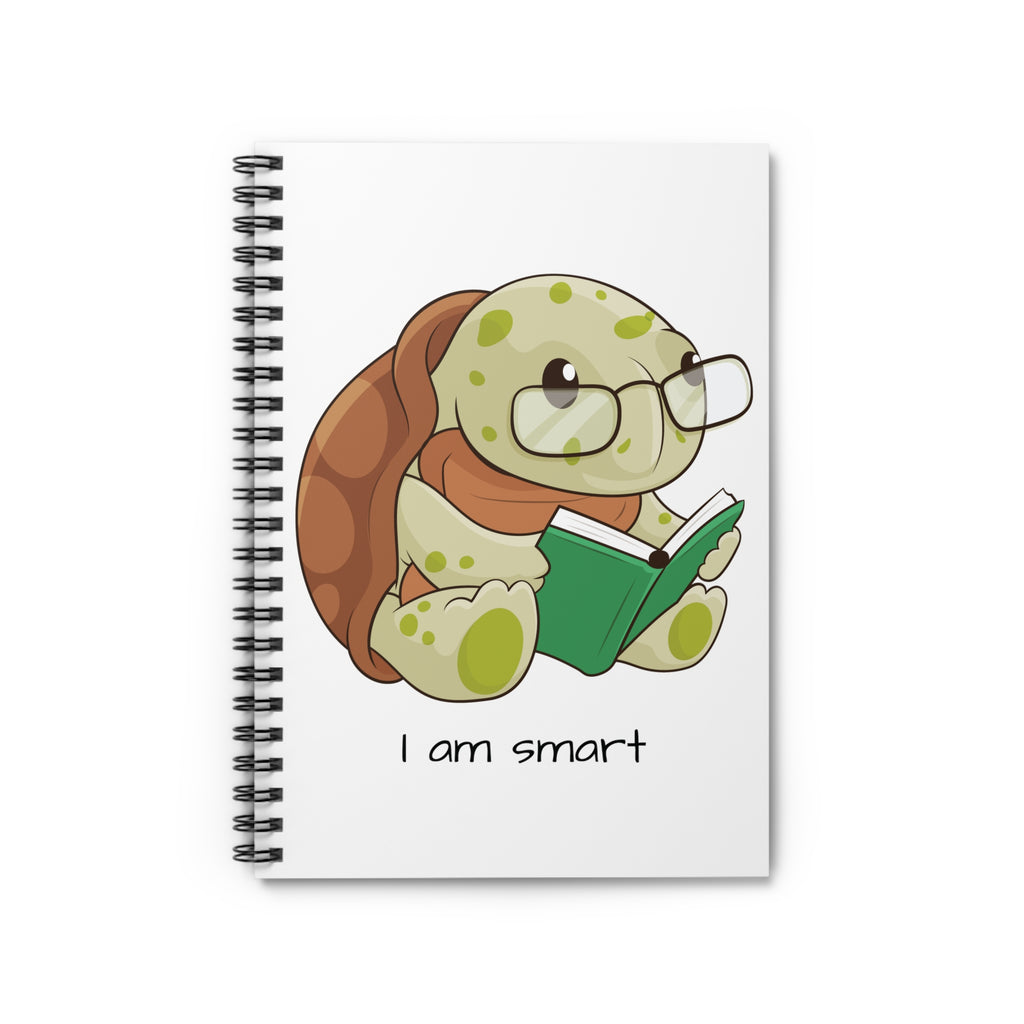 White spiral notebook laying closed, featuring a picture of a turtle that says I am smart.