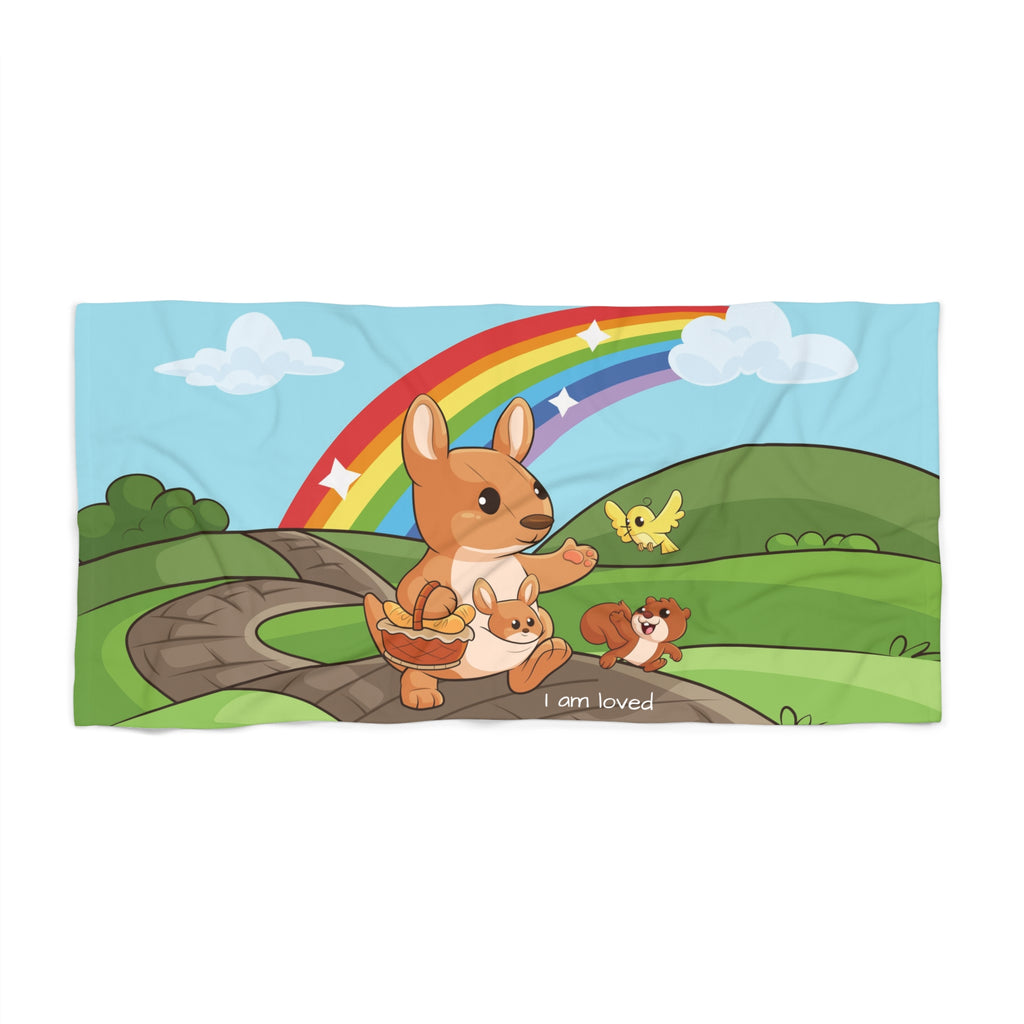 A 30 by 60 inch beach towel with a scene of a kangaroo walking along a path through rolling hills, a rainbow in the background, and the phrase "I am loved" along the bottom.