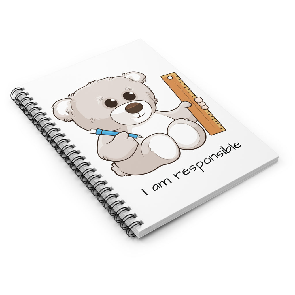 Side-view of a white spiral notebook laying closed, featuring a picture of a bear that says I am responsible.