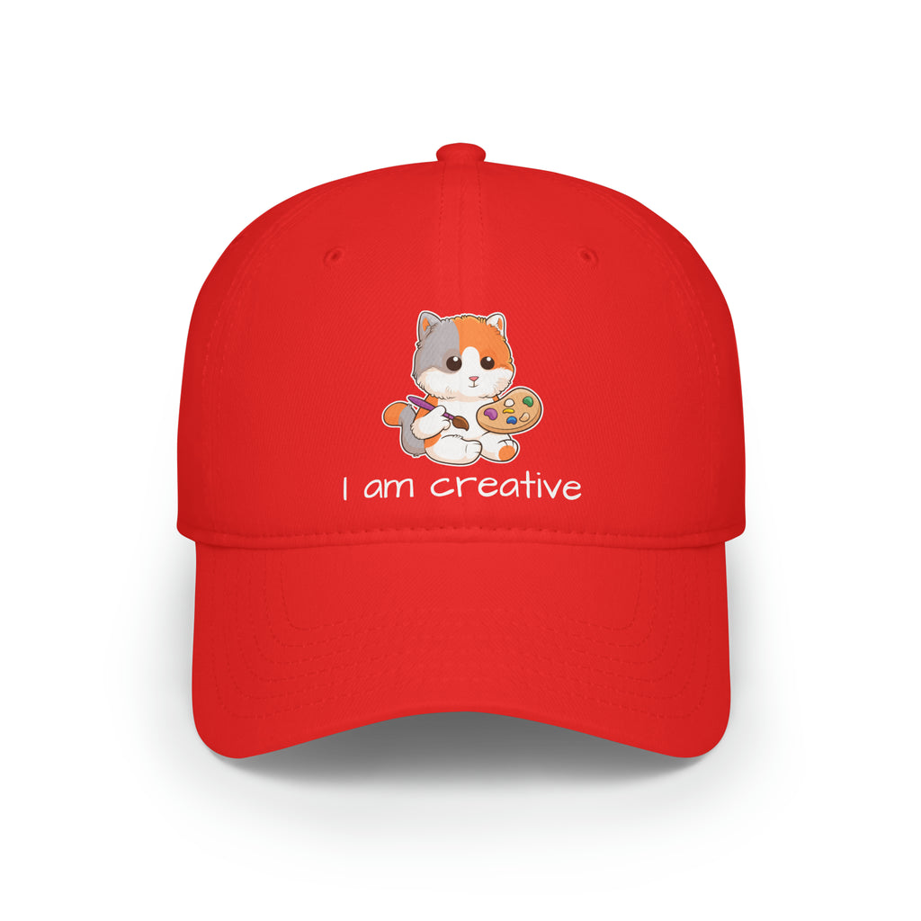 Front-view of a red baseball hat with a picture of a cat that says I am creative.