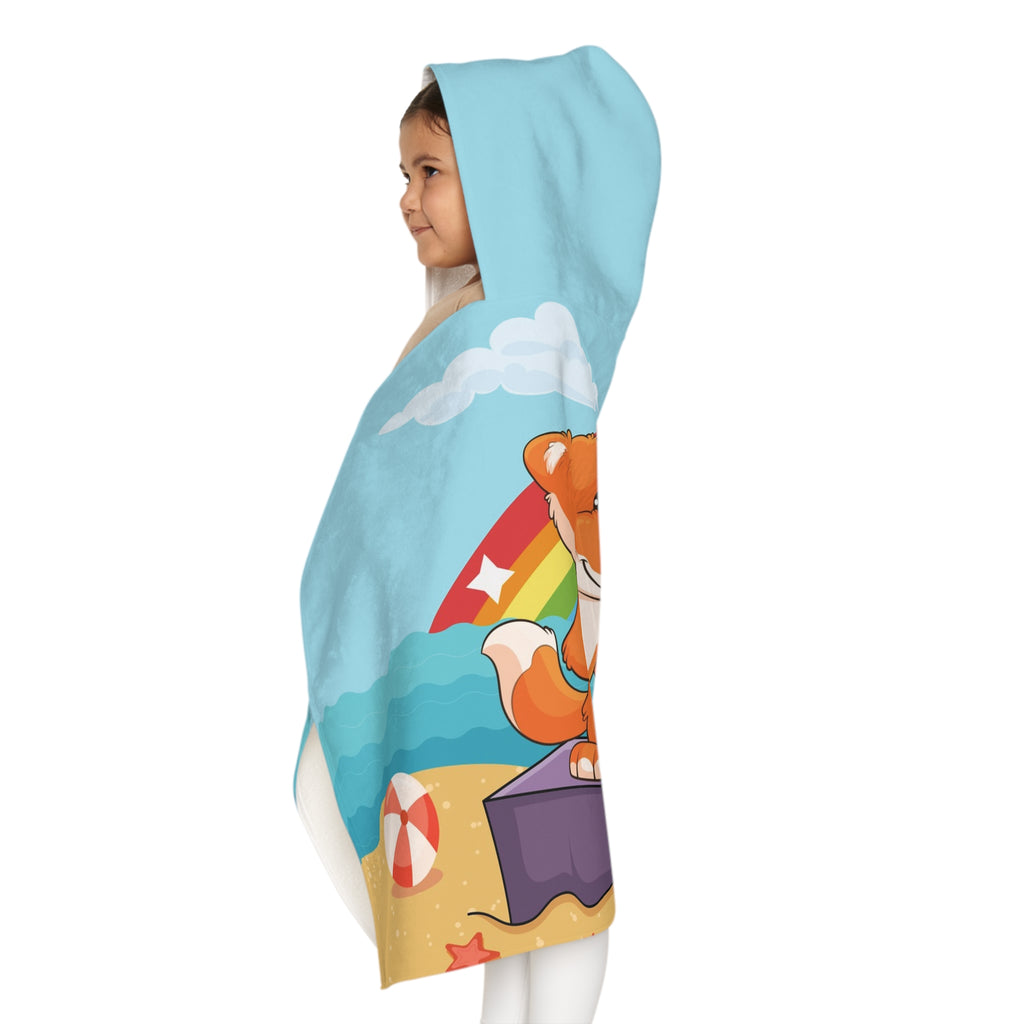 Left side-view of a girl wearing a hooded towel and holding it closed around her. The towel has a scene of a fox singing with a bird and squirrel on a stage on the beach, a rainbow in the background, and the phrase "I am a star" along the bottom.