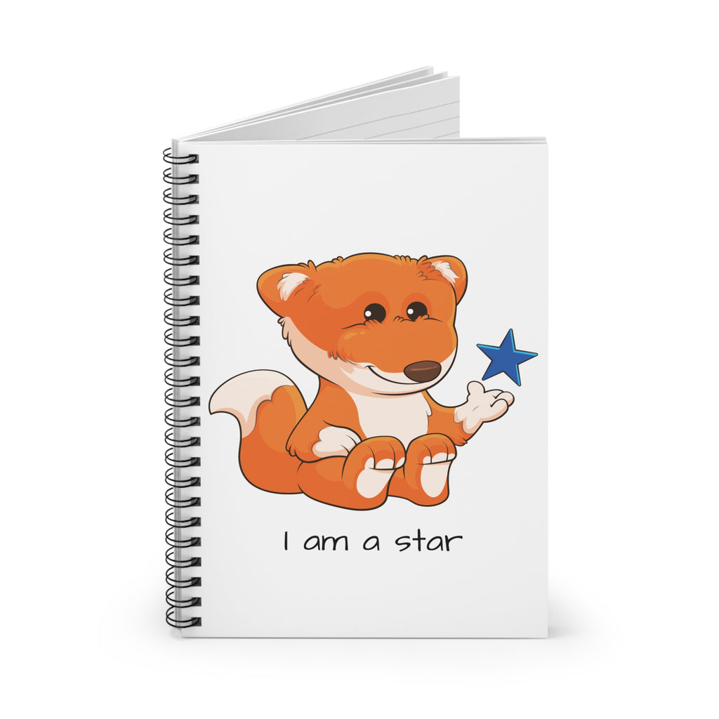 White spiral notebook standing up, featuring a picture of a fox that says I am a star on the front.