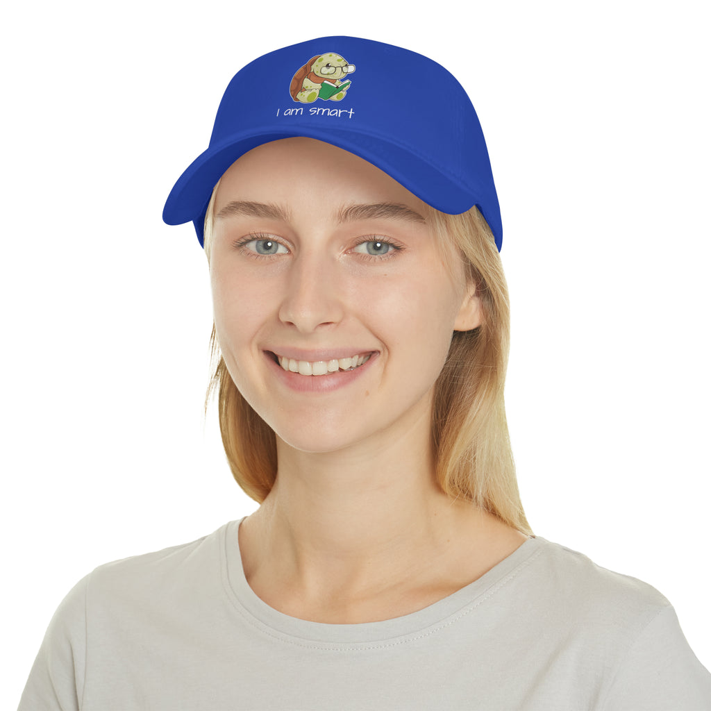 A female wearing a royal blue baseball hat with a picture of a turtle that says I am smart.