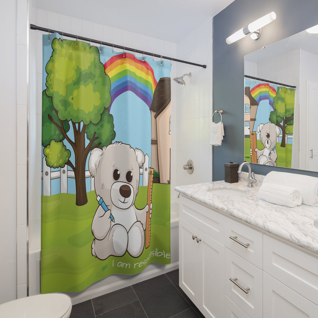 A shower curtain hanging from a rod in front of a built-in tub in a bathroom. The shower curtain has a scene of a bear sitting in the yard of its house with a rainbow in the background and the phrase "I am responsible" along the bottom.