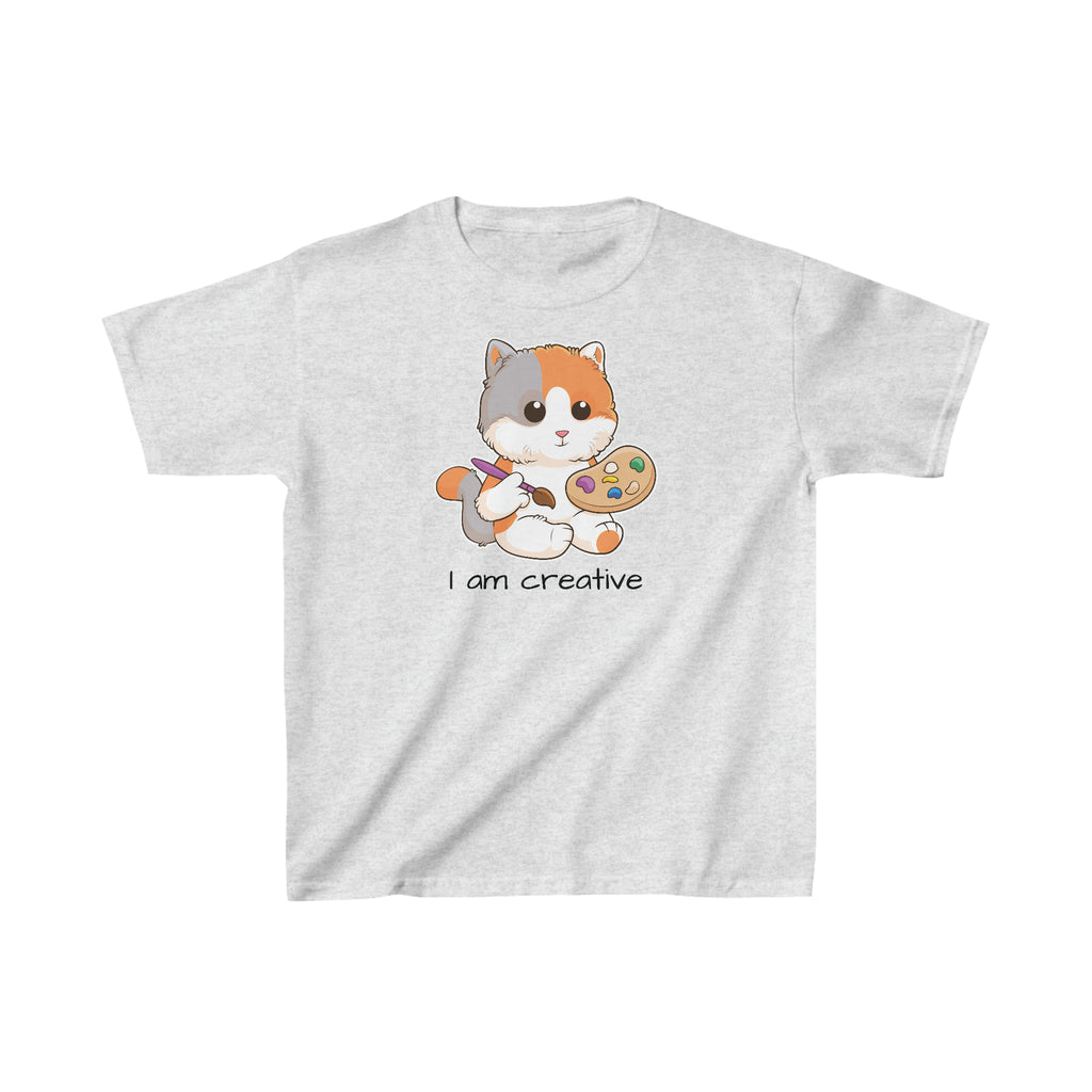 A short-sleeve light grey shirt with a picture of a cat that says I am creative.