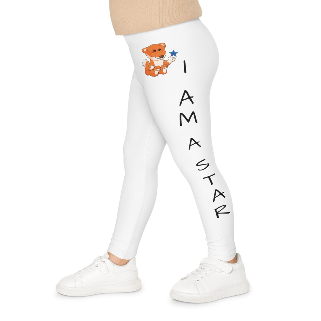 Left side-view of a child wearing white leggings with a picture of a fox on the front left waist and the phrase "I am a star" read top to bottom on the side of the leg.