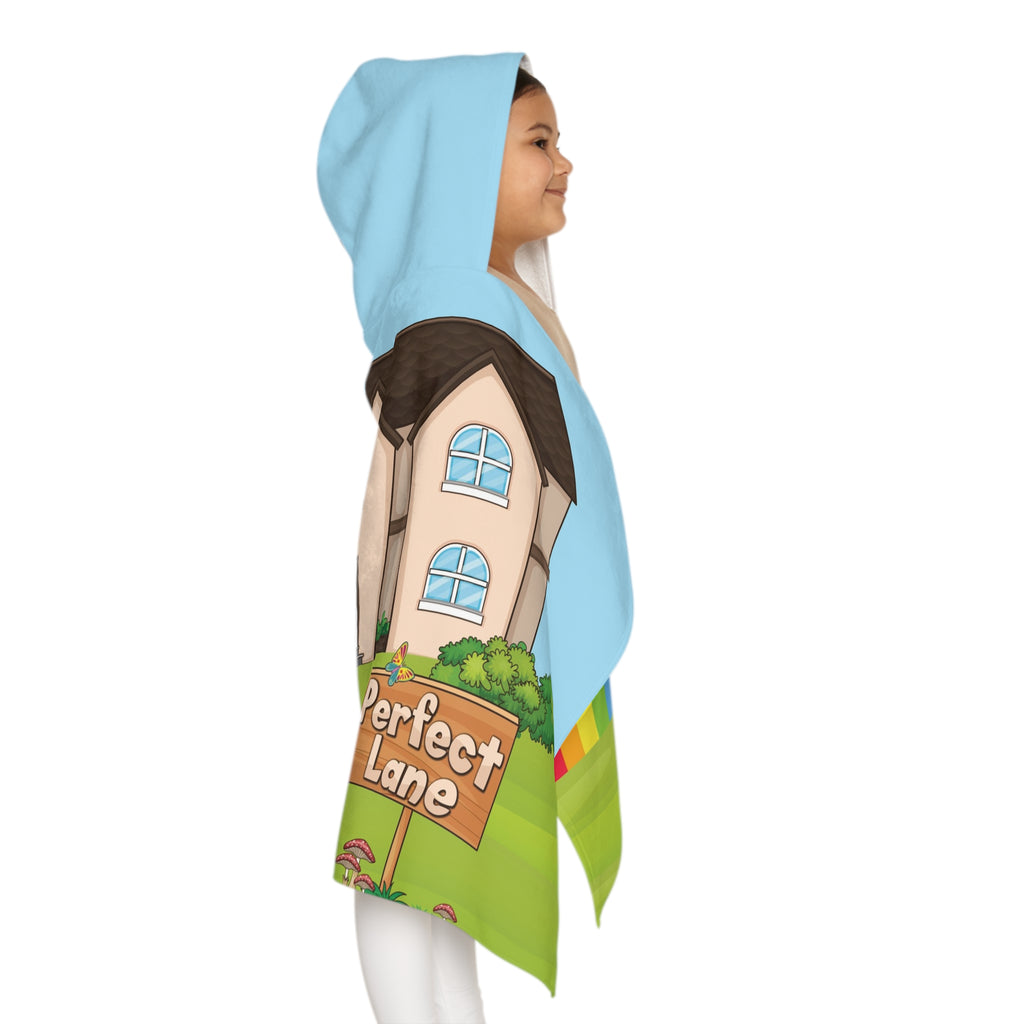 Right side-view of a girl wearing a hooded towel and holding it closed around her. The towel has a scene of a bear sitting in the yard of its house, a rainbow in the background, and the phrase "I am responsible" along the bottom.