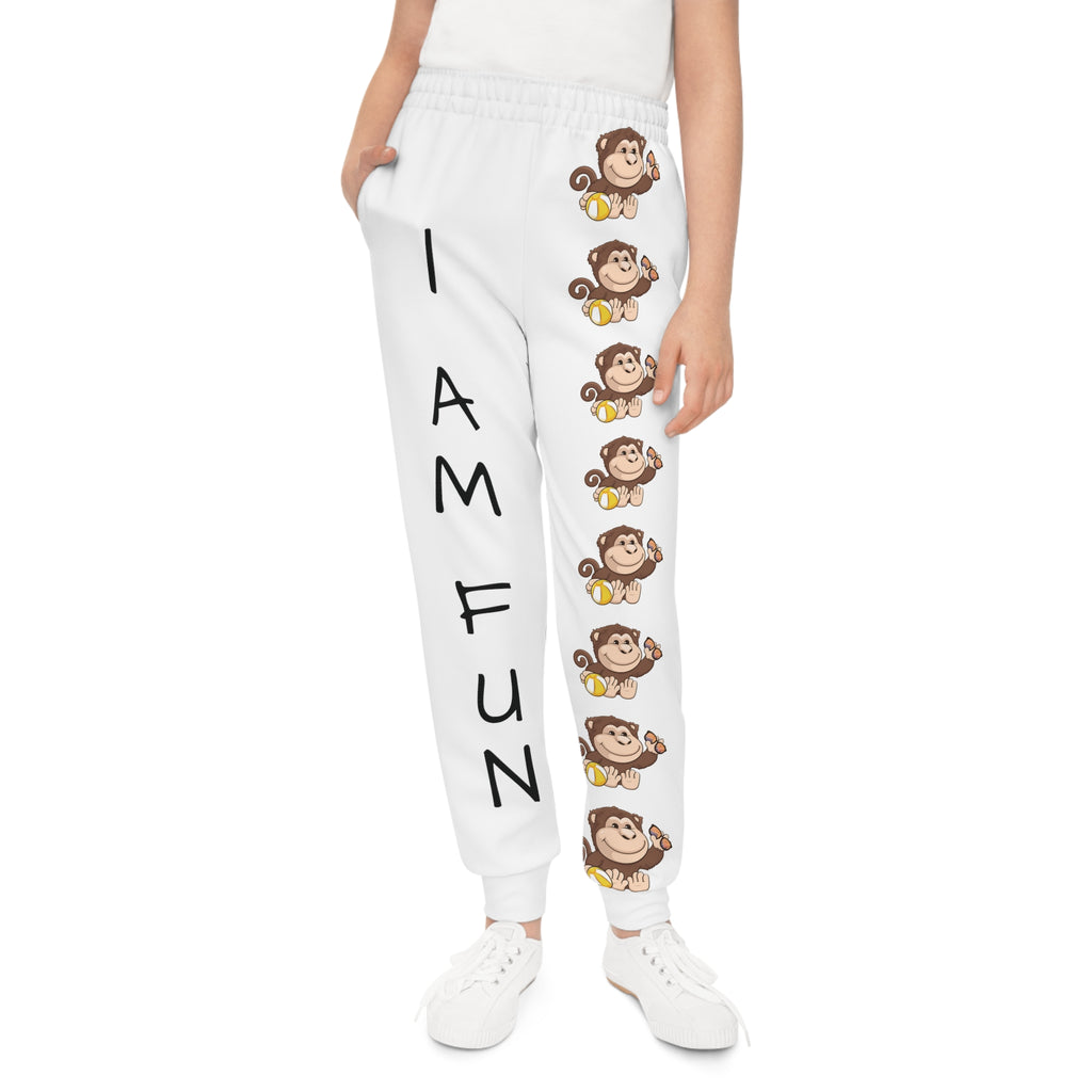 Front-view of a girl wearing white sweatpants with a line of monkeys down the front left leg and the phrase "I am fun" down the front right leg.