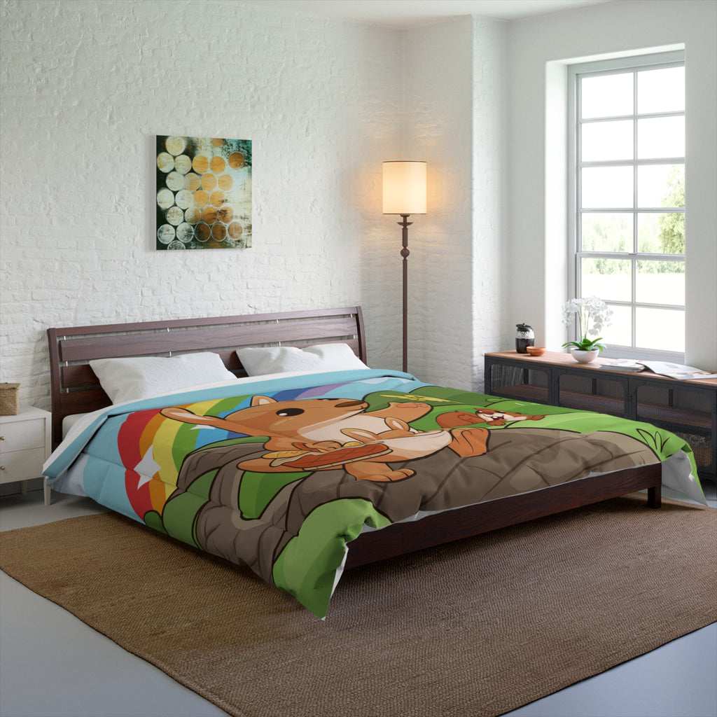 A 104 by 88 inch bed comforter with a scene of a kangaroo walking along a path through rolling hills, a rainbow in the background, and the phrase "I am loved". The comforter covers a queen-sized bed.