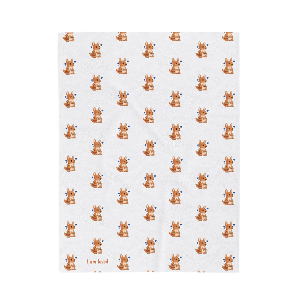 A blanket that has a repeating pattern of a kangaroo and the phrase “I am loved” in the bottom left corner.