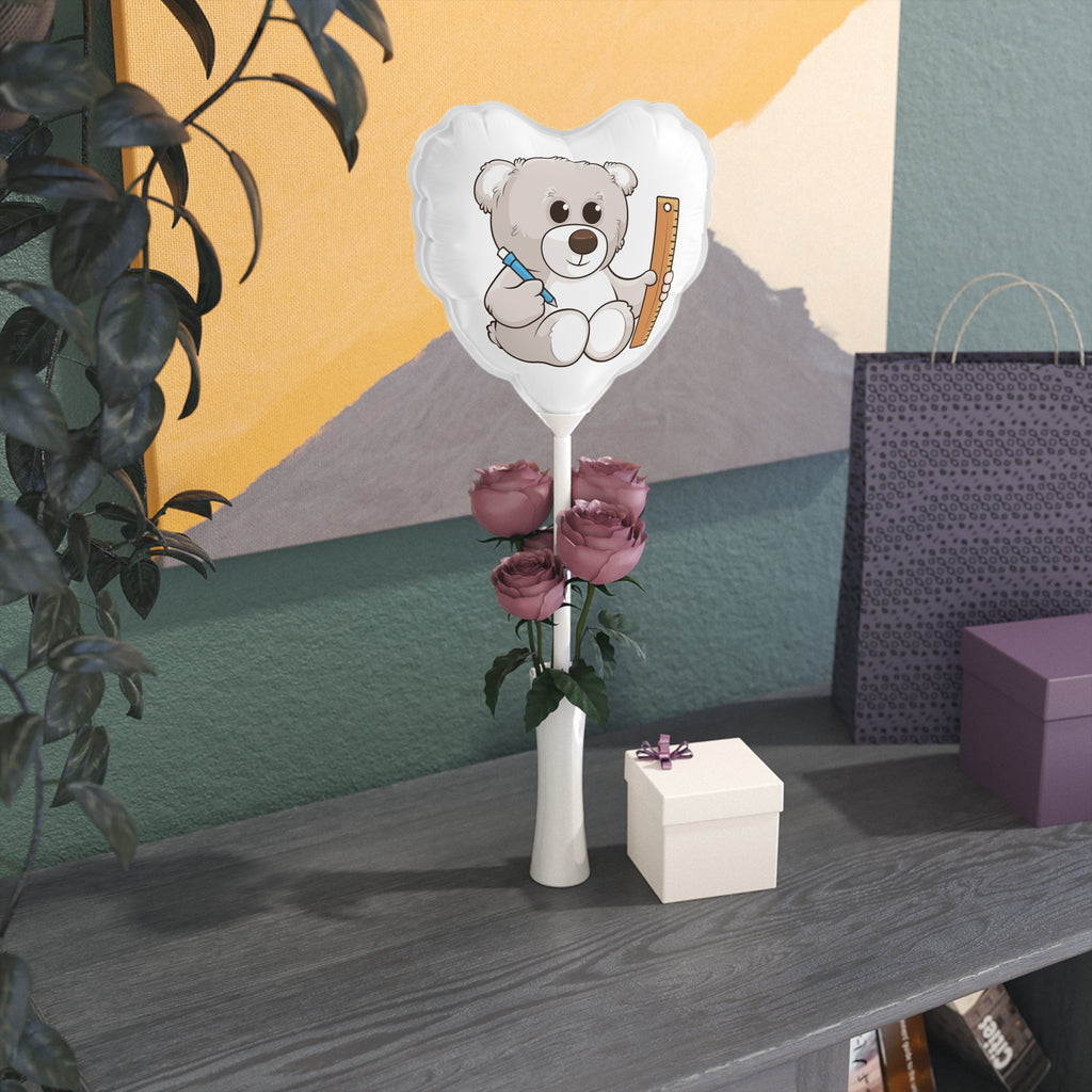 A heart-shaped white mylar balloon on a stick with a picture of a bear. The balloon sits in a flower vase on a gift table.