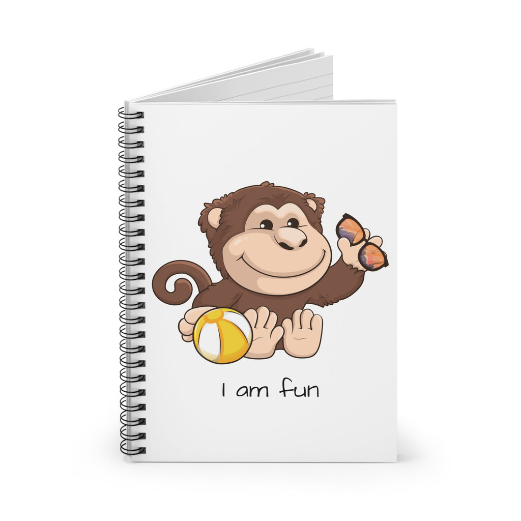 White spiral notebook standing up, featuring a picture of a monkey that says I am fun.