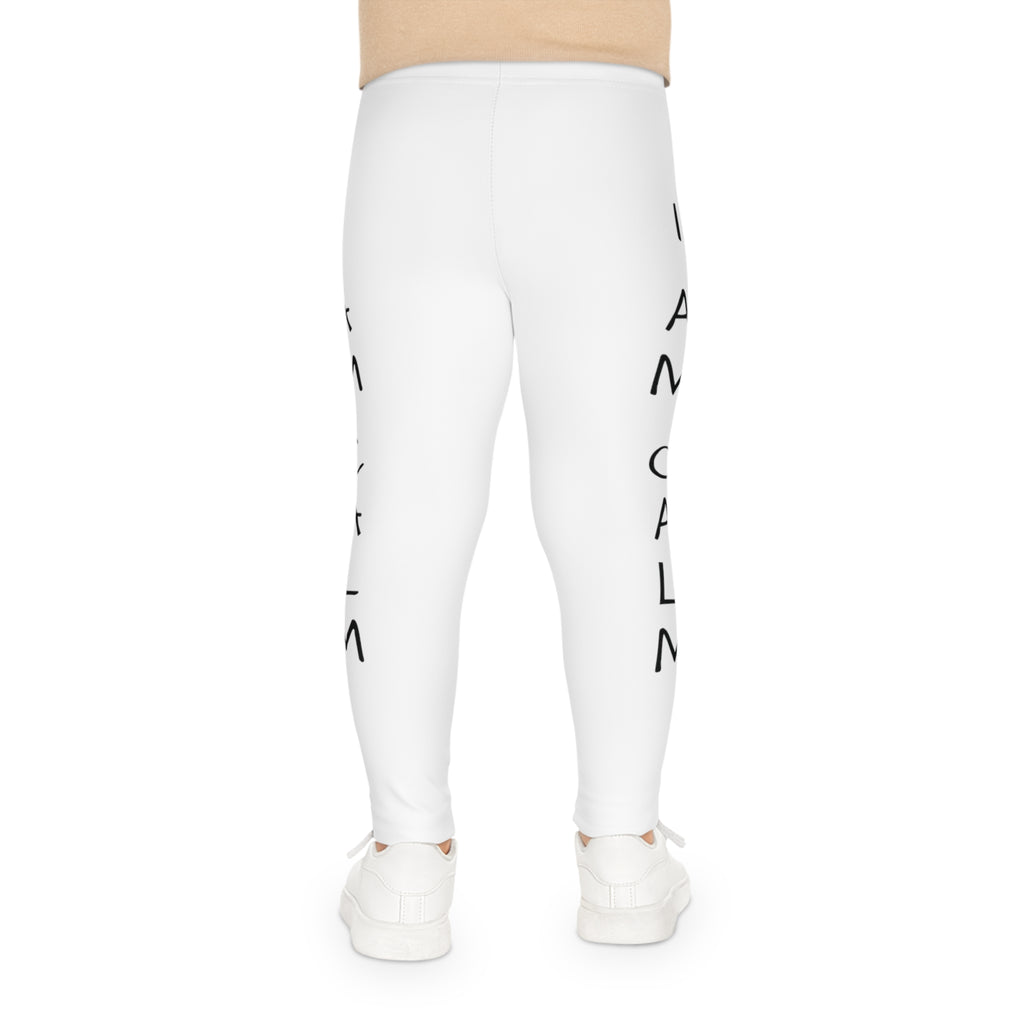 Back-view of a child wearing white leggings with the phrase "I am calm" read top to bottom on the side of each leg.