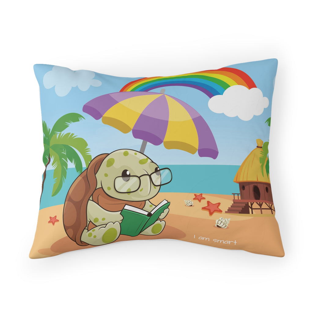 A pillowcase with a scene of a turtle reading a book under an umbrella on the beach, a rainbow in the background, and the phrase "I am smart" along the bottom.