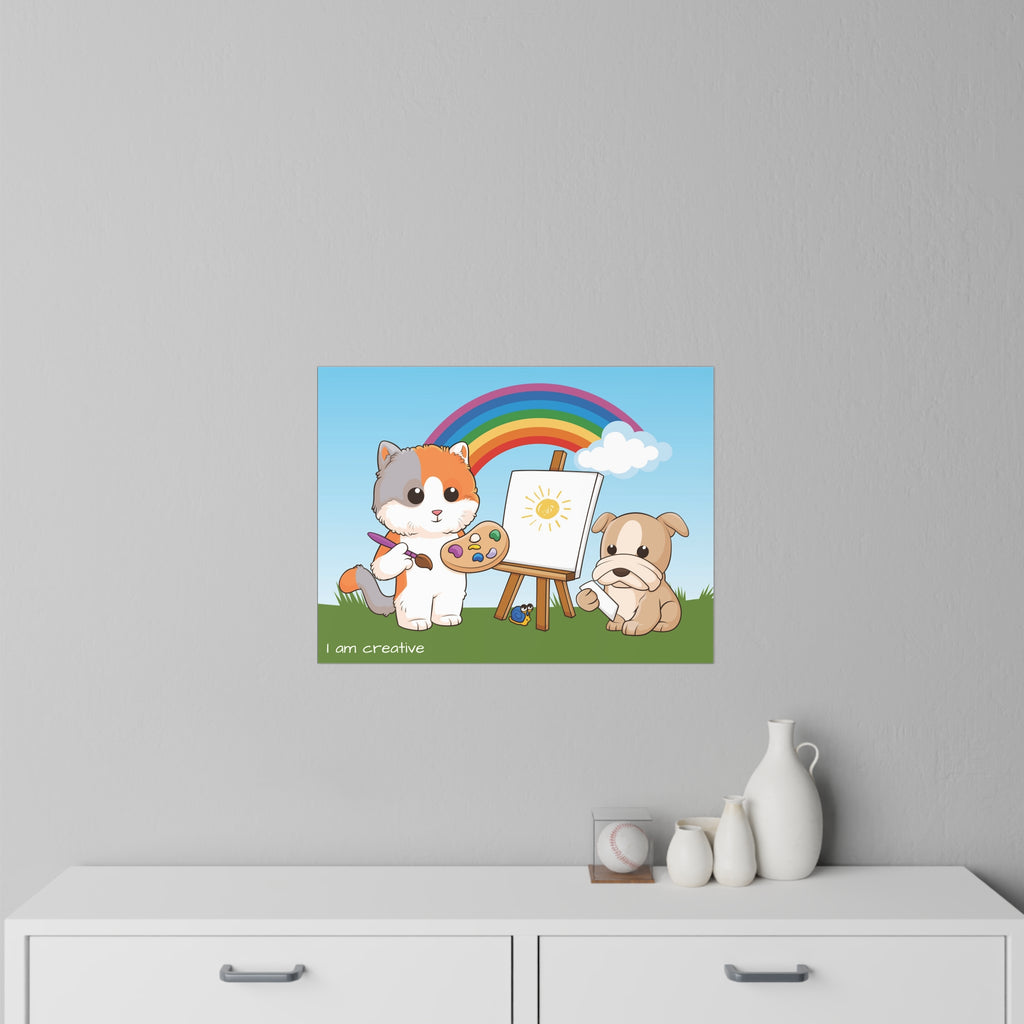 A 24 by 18 inch wall decal on a grey wall above a dresser. The wall decal has a scene of a cat painting on a canvas next to a dog, a rainbow in the background, and the phrase "I am creative" along the bottom.