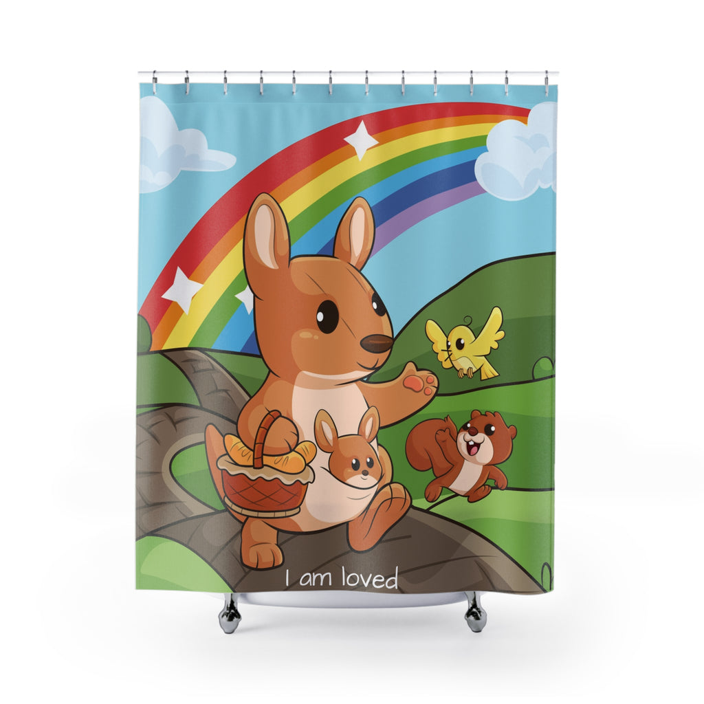 A shower curtain hanging from a rod in front of a stand-alone tub. The shower curtain has a scene of a kangaroo walking on a path through rolling hills with a rainbow in the background and the phrase "I am loved" along the bottom.