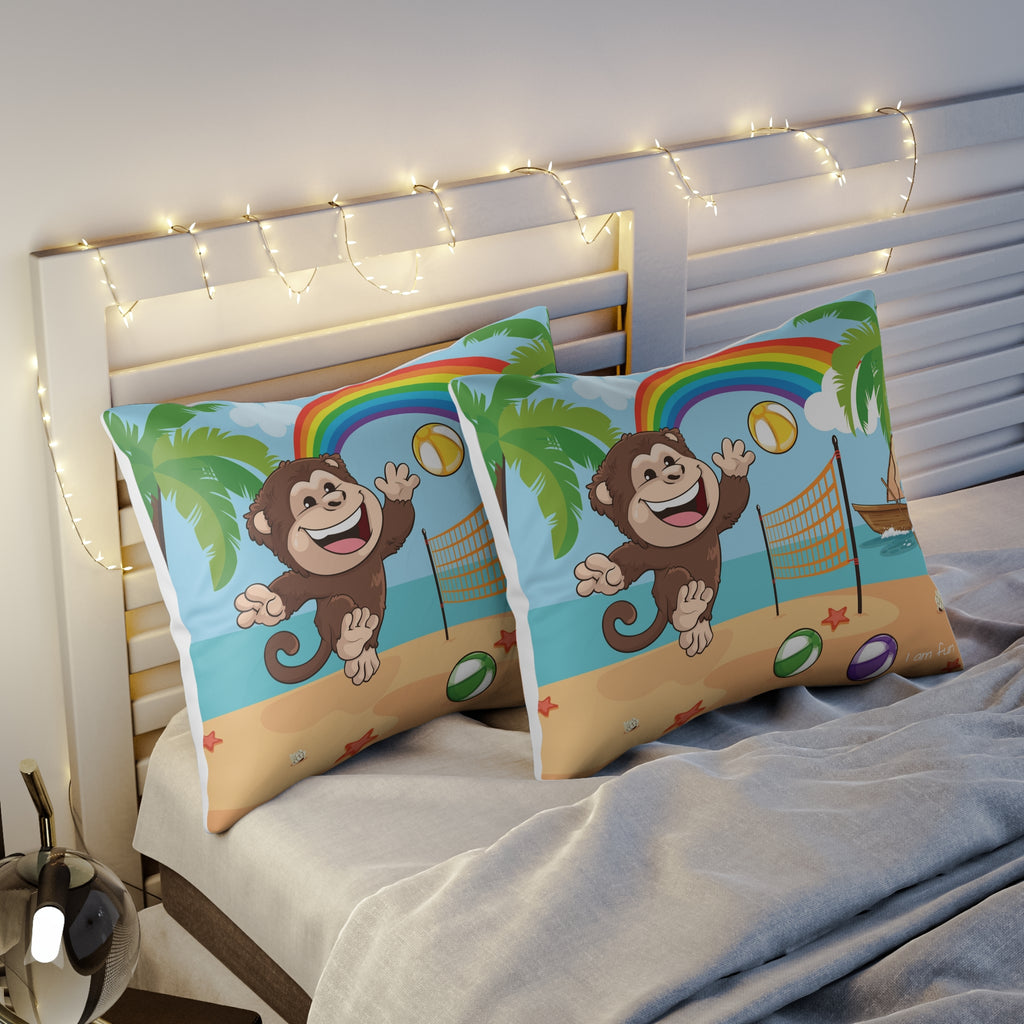 Two pillows sitting on a bed. The pillows have on pillowcases with a scene of a monkey playing volleyball on the beach, a rainbow in the background, and the phrase "I am fun" along the bottom.