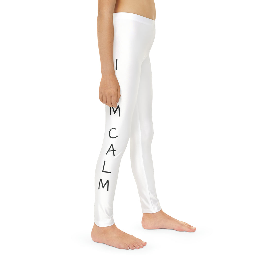 Right side-view of a child wearing white leggings with a picture of an elephant on the front left waist and the phrase "I am calm" read top to bottom on the side of each leg.