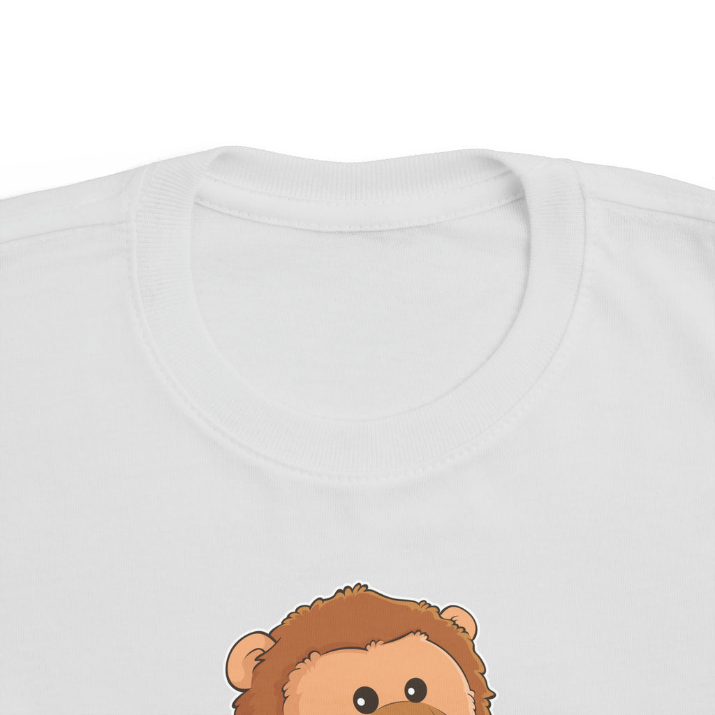 A close-up of the crew neckline of a short-sleeve grey shirt with a picture of a lion that says I am strong.