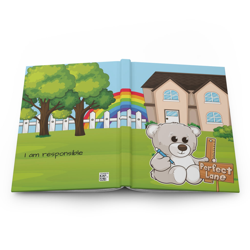 A hardcover journal laying open with the cover facing up. The journal cover is a scene of a bear in the yard of its house with a rainbow in the background.