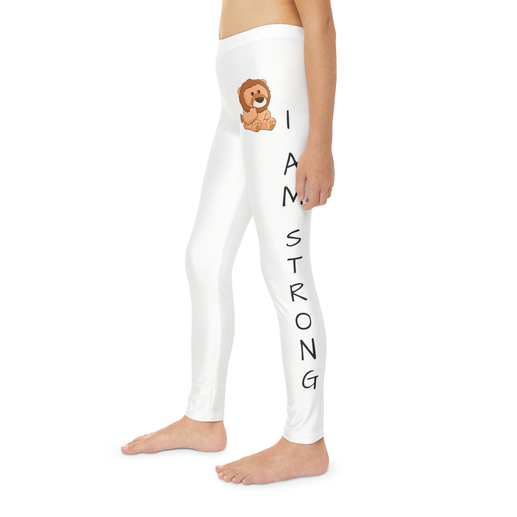 Left side-view of a child wearing white leggings with a picture of a lion on the front left waist and the phrase "I am strong" read top to bottom on the side of each leg.