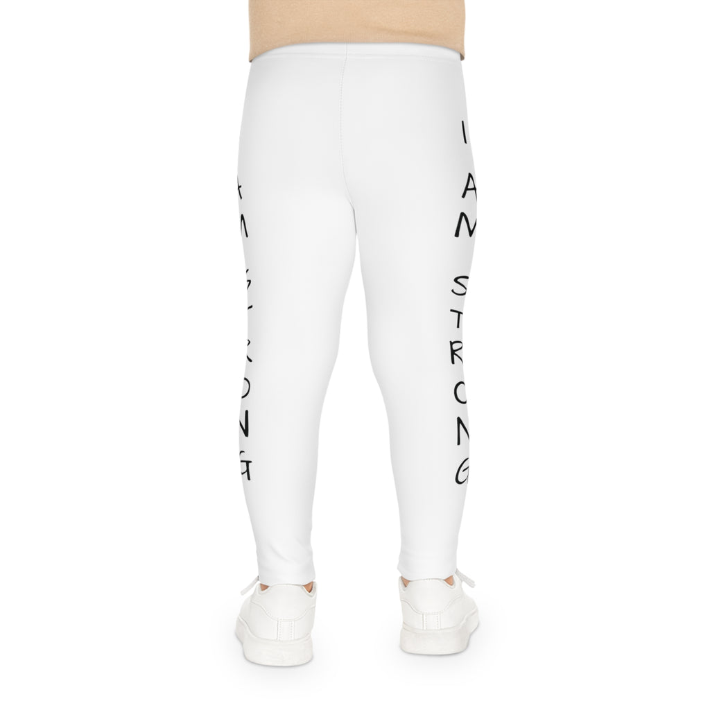 Back-view of a child wearing white leggings with the phrase "I am strong" read top to bottom on the side of each leg.