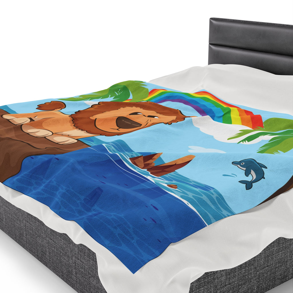 Side-view of a 60 by 80 inch blanket on a queen-sized bed. The blanket has a scene of a lion standing on a cliff over the ocean, a rainbow in the background, and the phrase "I am strong" along the bottom.