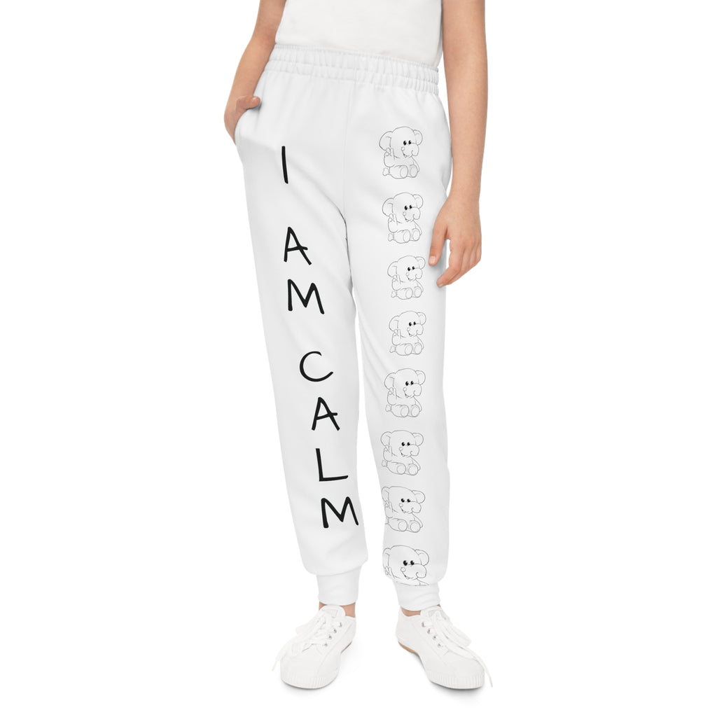 Front-view of a girl wearing white sweatpants with a line of black and white elephants down the front left leg and the phrase "I am calm" down the front right leg.