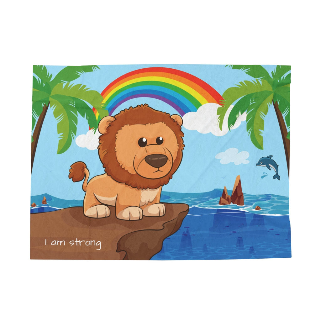 A blanket that has a scene of a lion standing on a cliff over the ocean, a rainbow in the background, and the phrase "I am strong" along the bottom.