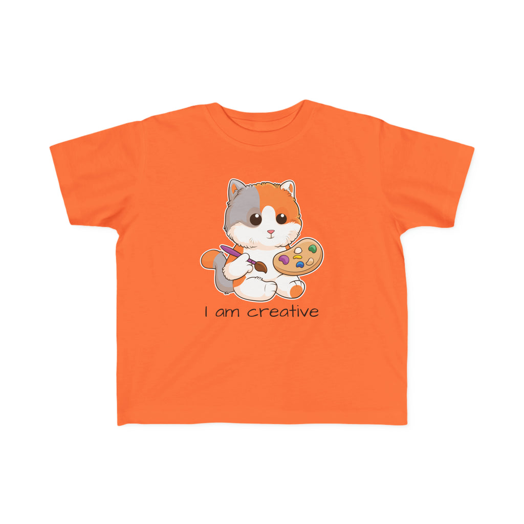 A short-sleeve orange shirt with a picture of a cat that says I am creative.
