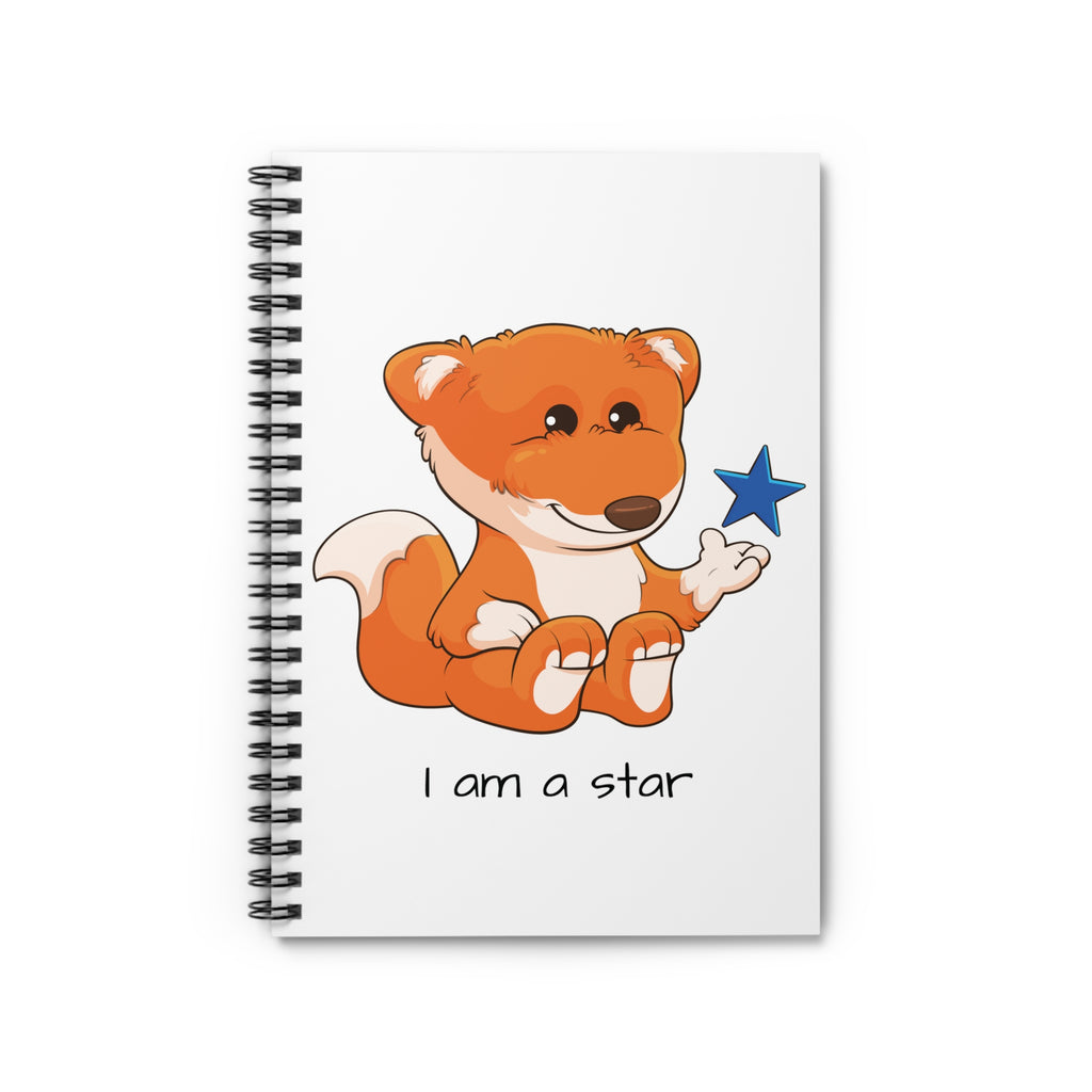 White spiral notebook laying closed, featuring a picture of a fox that says I am a star.