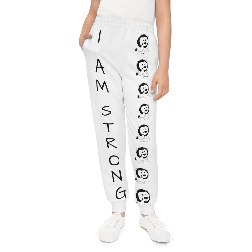 Front-view of a girl wearing white sweatpants with a line of black and white lions down the front left leg and the phrase "I am strong" down the front right leg.