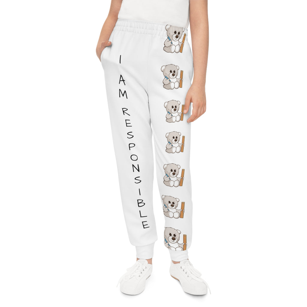 Front-view of a girl wearing white sweatpants with a line of bears down the front left leg and the phrase "I am responsible" down the front right leg.
