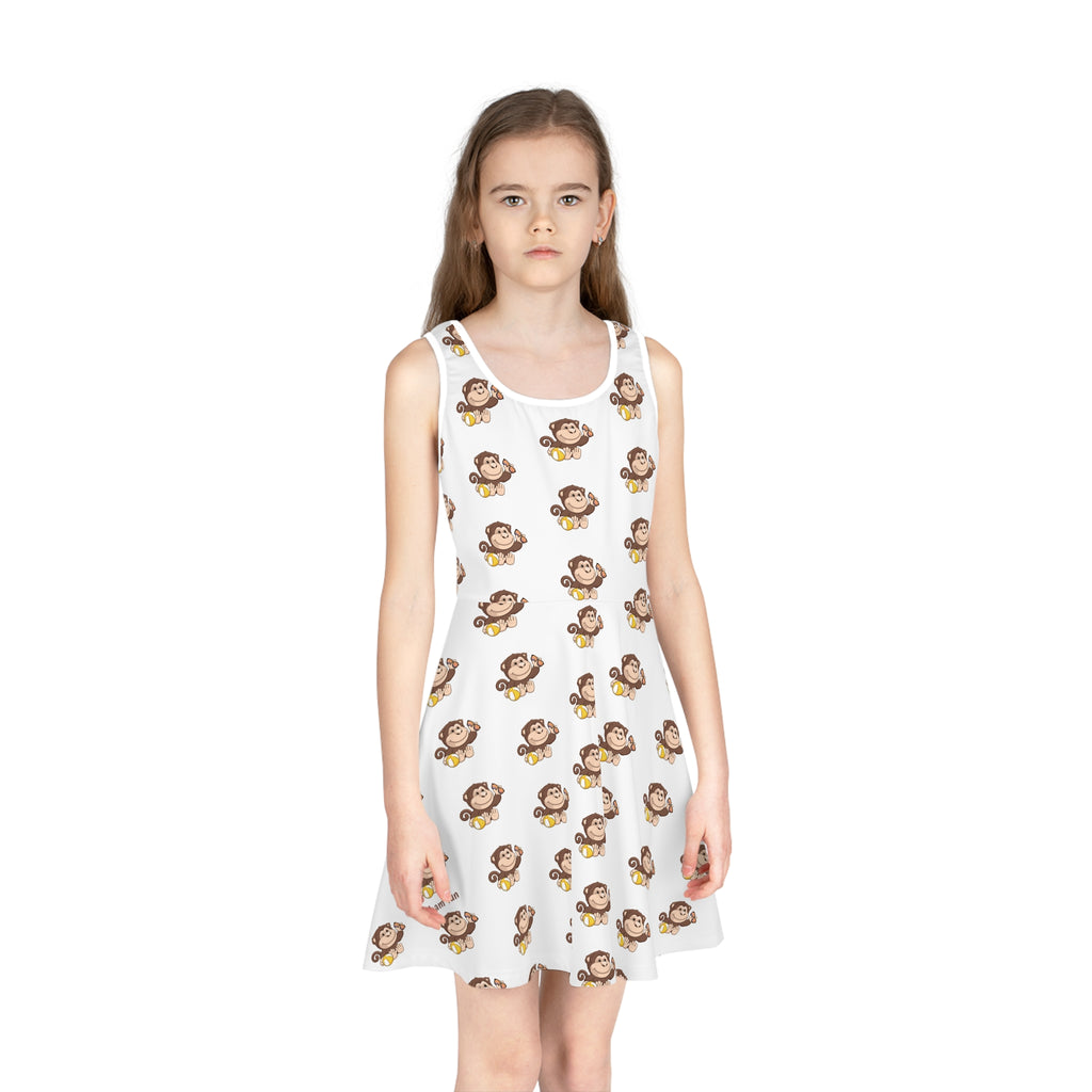 Front-view of a girl wearing a sleeveless white dress with a repeating pattern of a monkey.