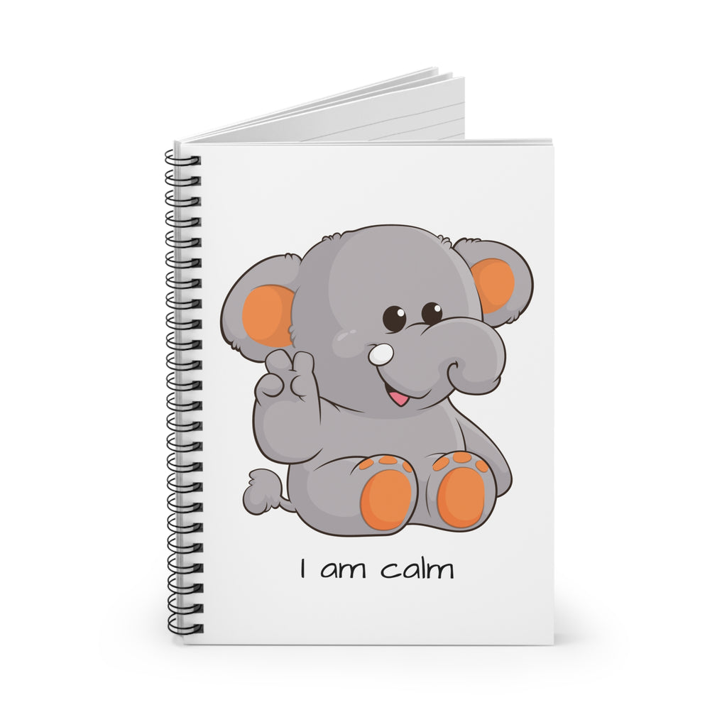 White spiral notebook standing up, featuring a picture of an elephant that says I am calm on the front.