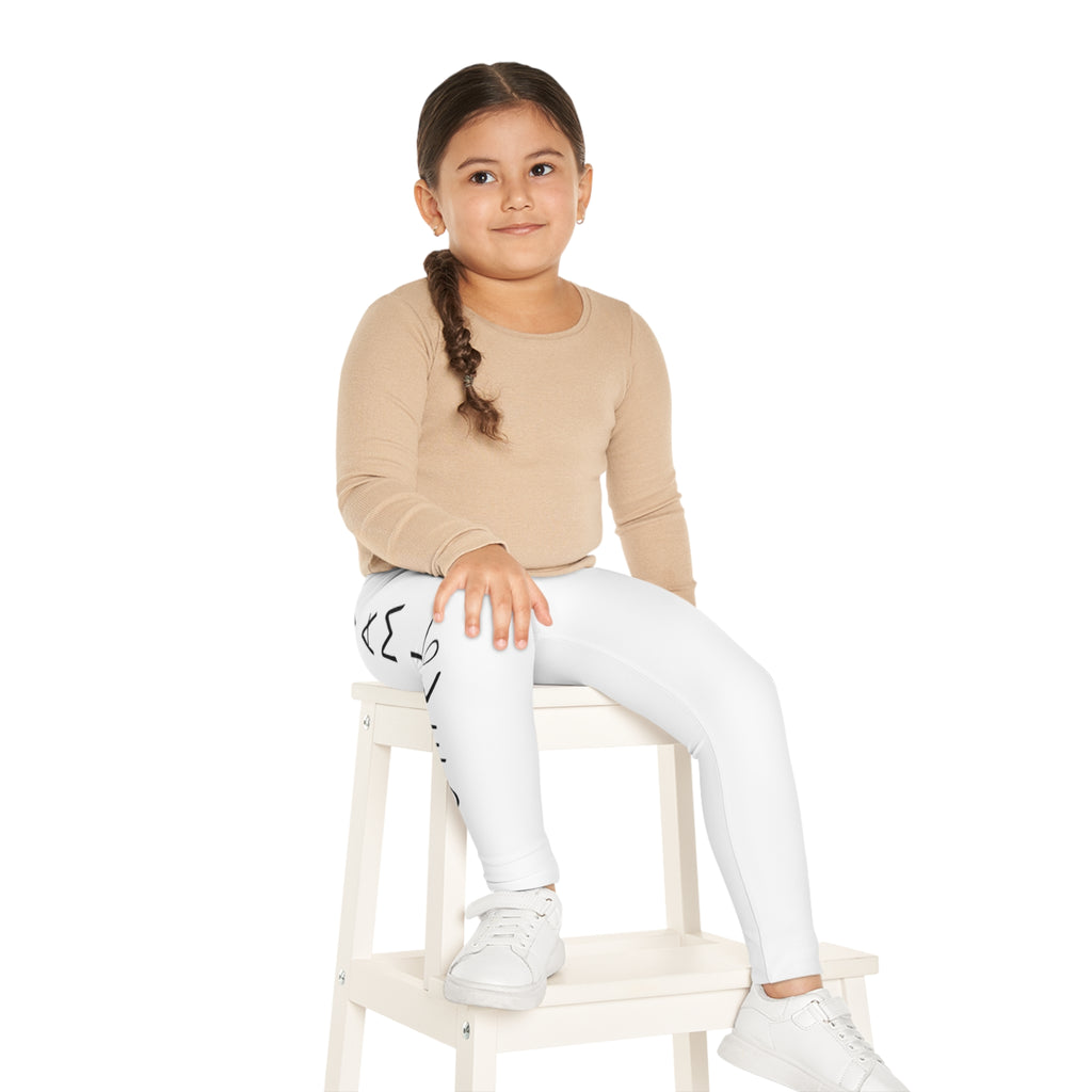 A little girl sitting on a stool and wearing white leggings with a picture of a kangaroo on the front left waist and the phrase "I am loved" read top to bottom on the side of each leg.