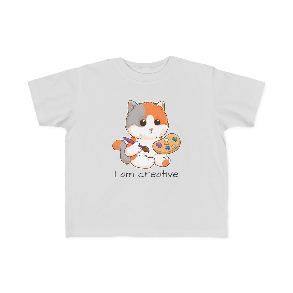 A short-sleeve grey shirt with a picture of a cat that says I am creative.