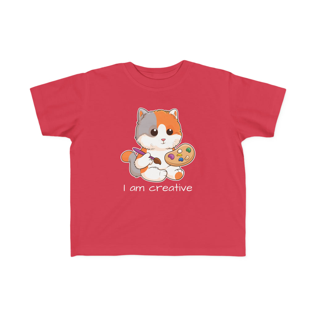 A short-sleeve red shirt with a picture of a cat that says I am creative.