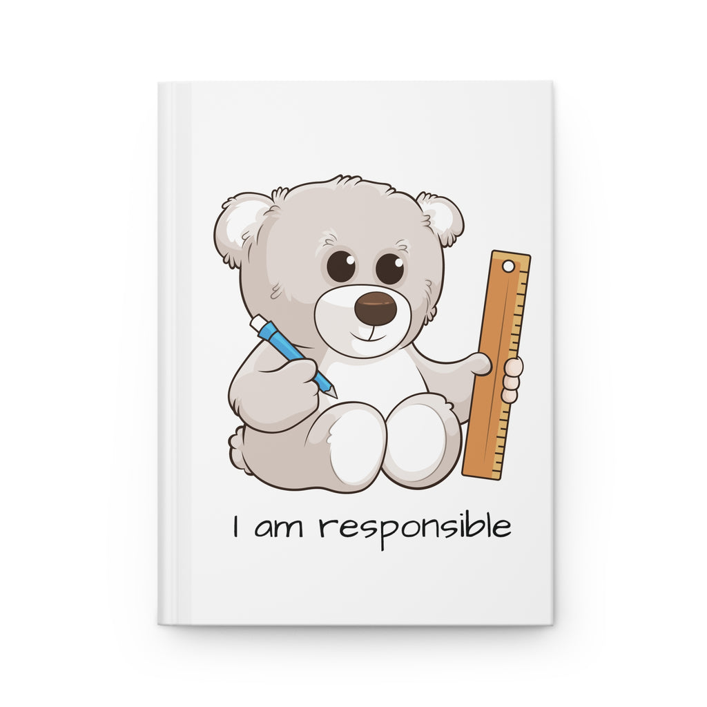 White hardcover journal laying closed, featuring a picture of a bear that says I am responsible.